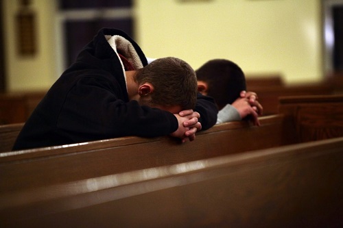 Young-Men-Praying-in-Church
